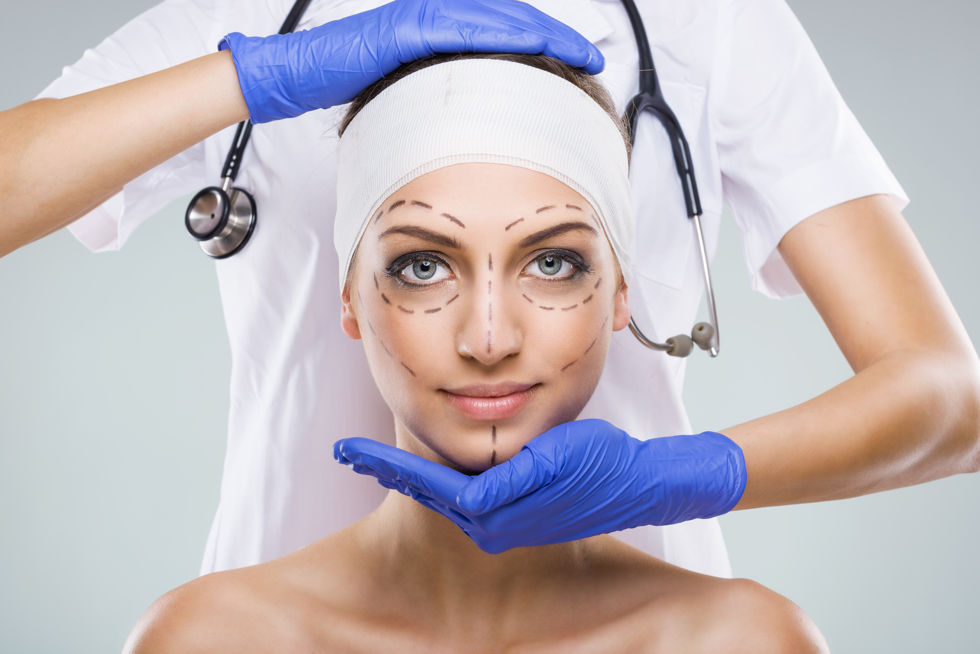 girl with markings on her face for cosmetic surgery